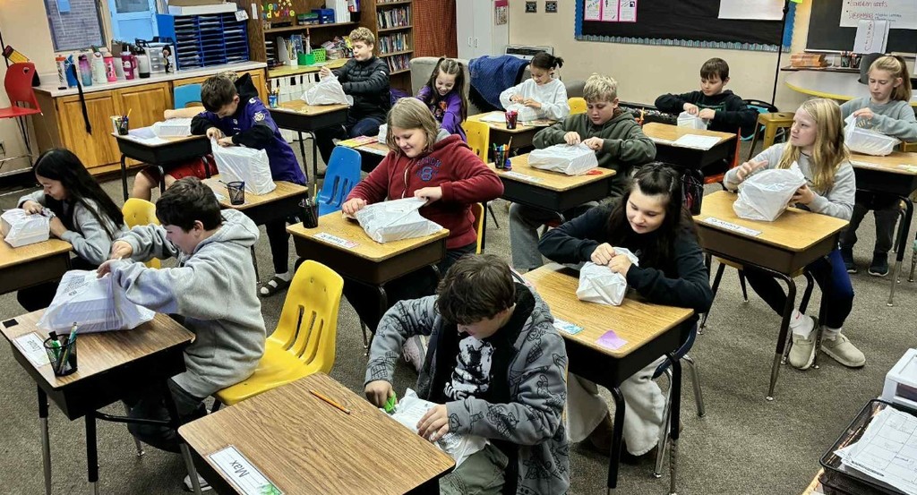 the 5th graders opening their books.