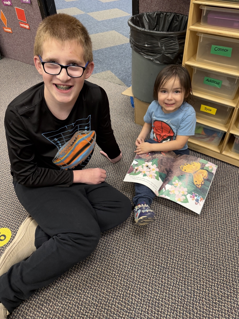 2 boys reading a book