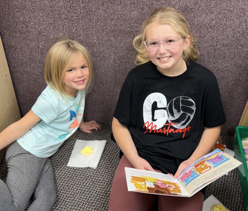 sisters reading a book