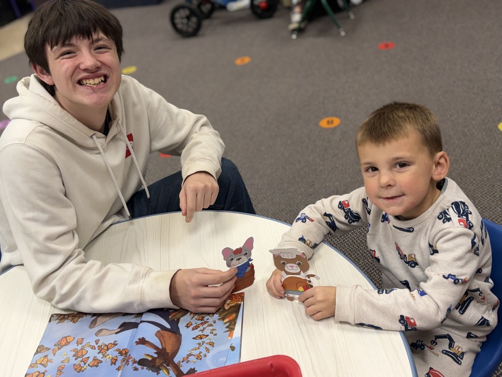 2 boys making a craft