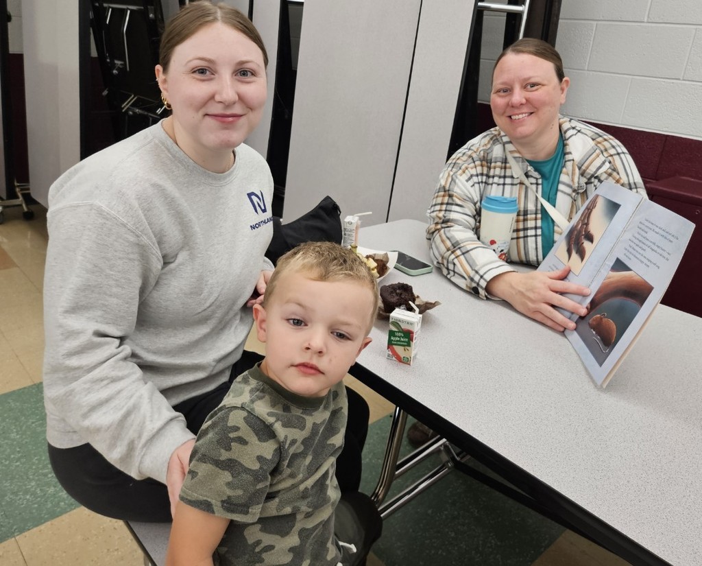a family and their boy reading a book 
