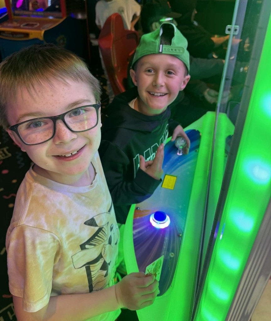 2 boys having fun at the arcade