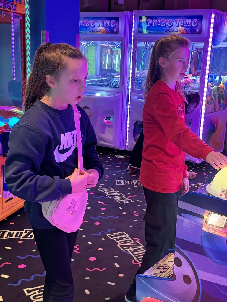 2 girls playing arcade games