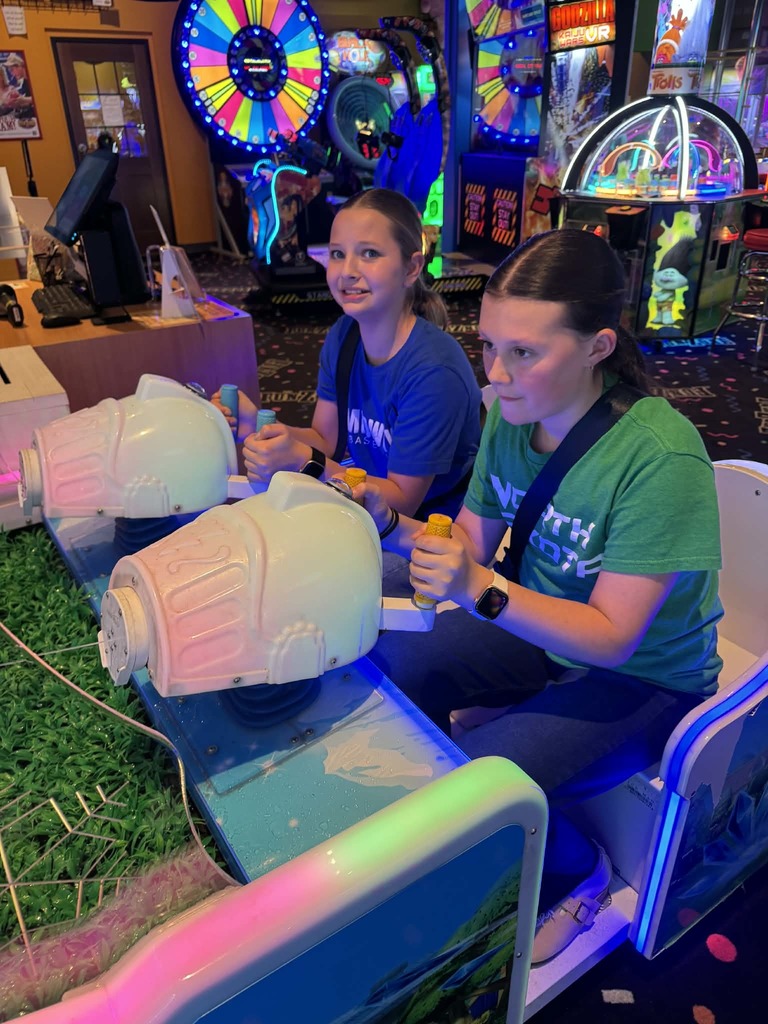 2 girls playing in the arcade