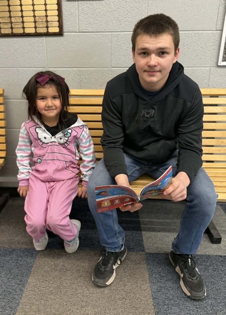 a boy and a girl reading