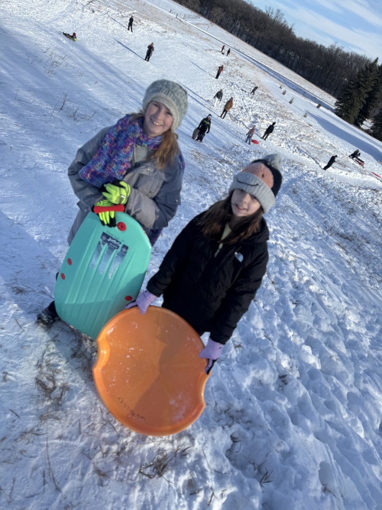 2 girls with sleds