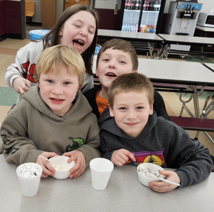 4 kids enjoying treats
