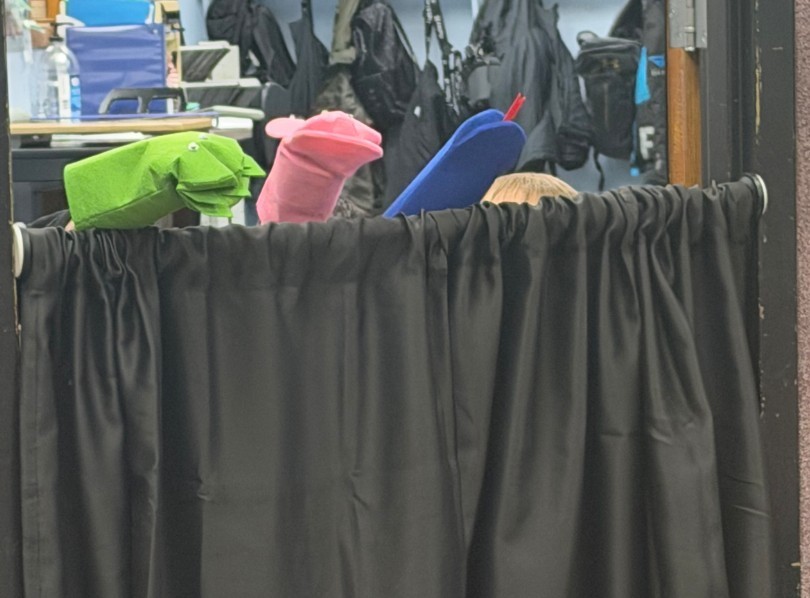 kids doing their puppets show