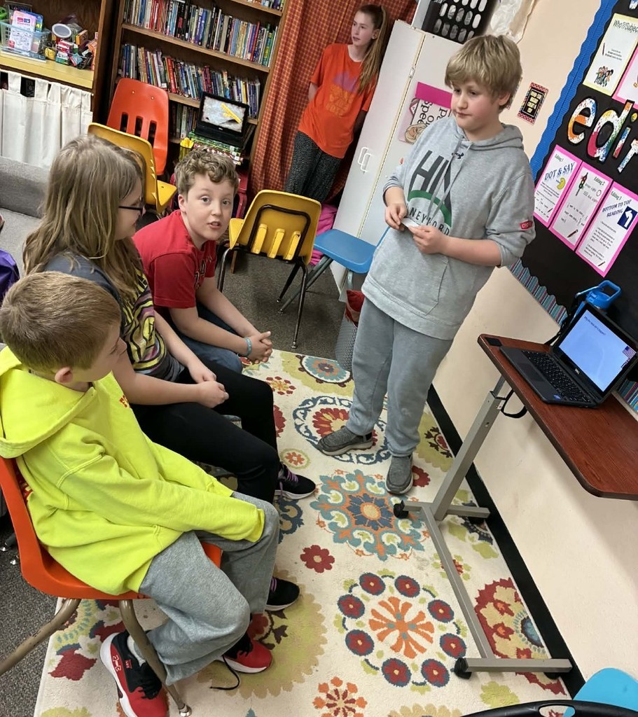a boy presenting to some 3rd graders