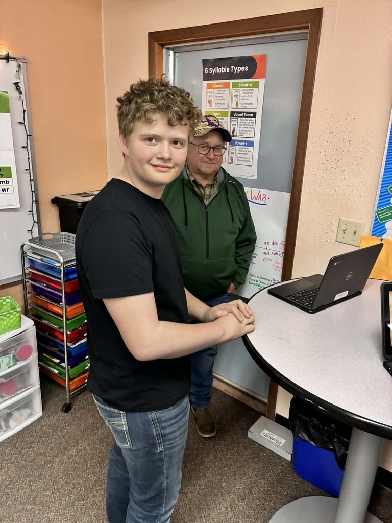 a boy presenting to a guest