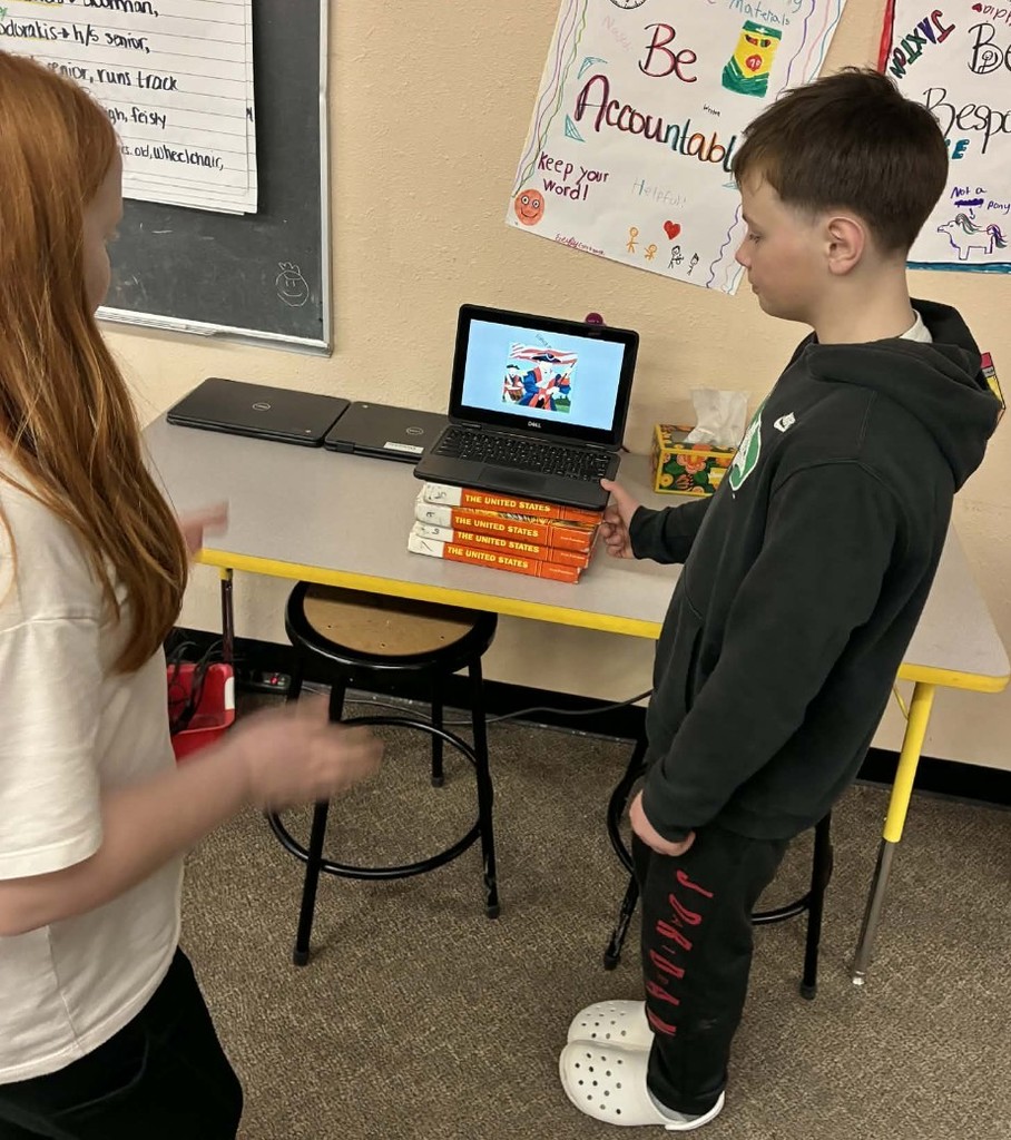a boy presenting to a student