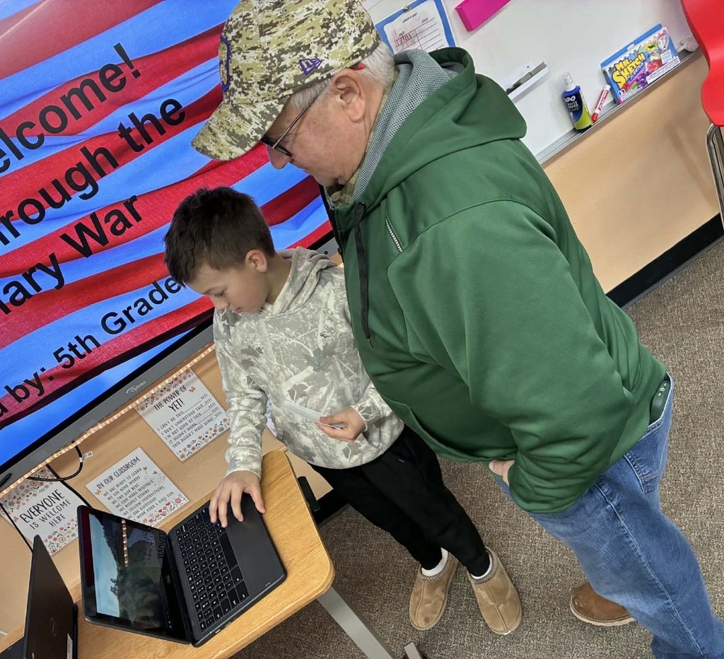 a boy presenting to his grandpa