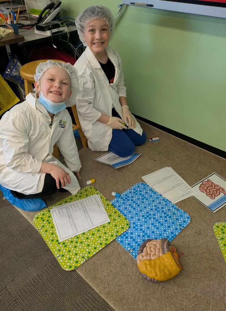 2 kids working on a patienr