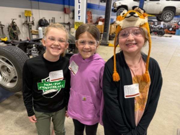 3 girls learning about cars.
