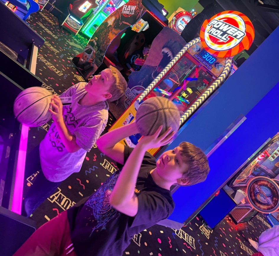 2 boys playing basketball 