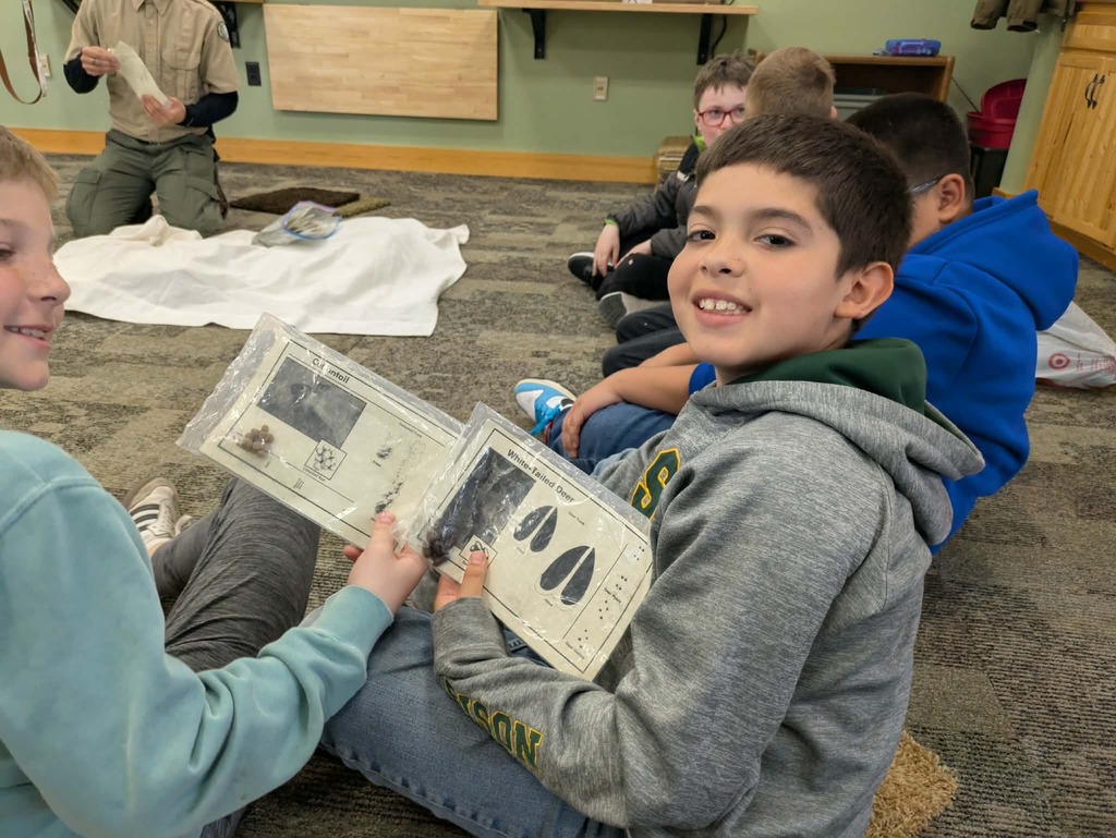 boys learning about animal tracks