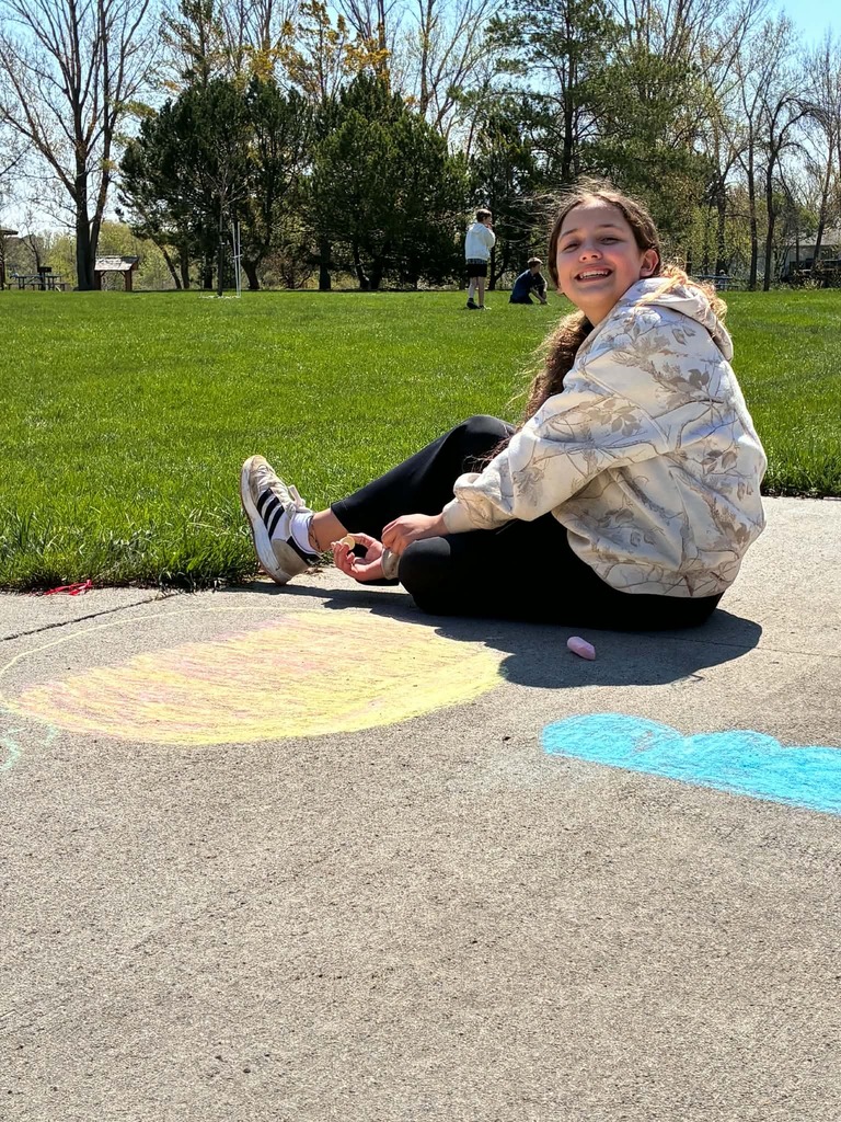 a girl drawing with chalk