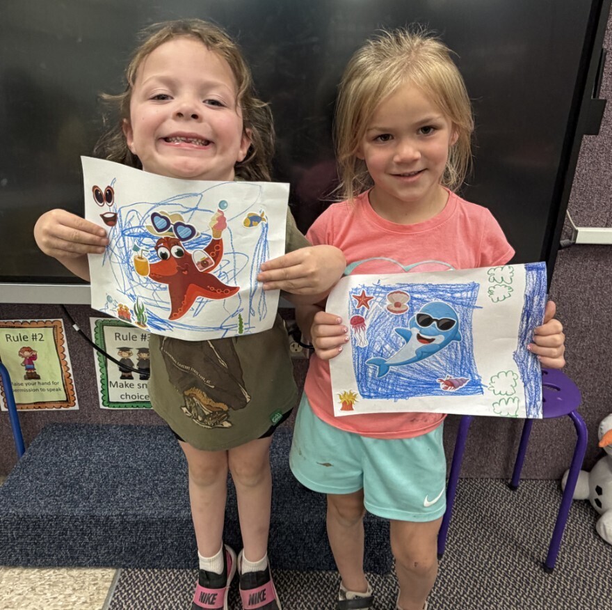 2 girls and their ocean pictures.
