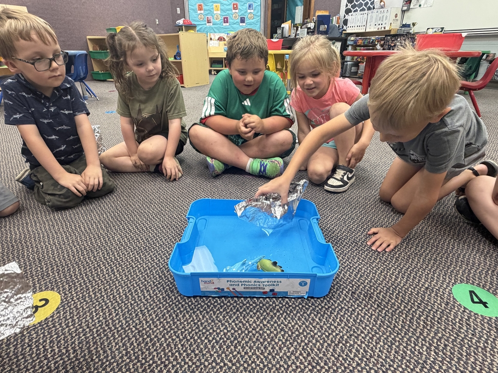 kids testing out their foil boats in the water
