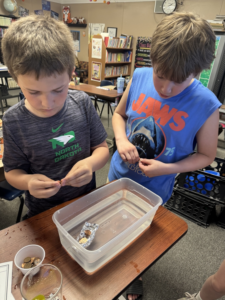 2 boys filling their boat with pennies