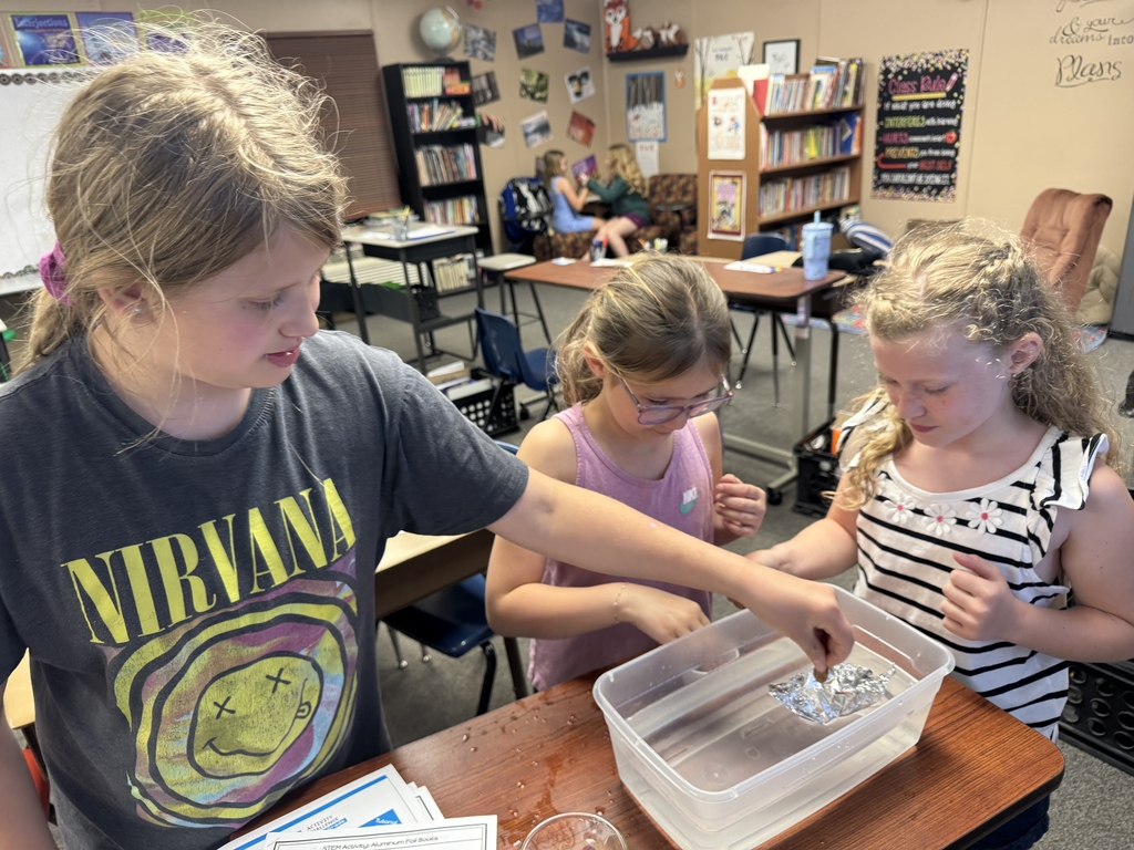 the girls filling their foil boats.