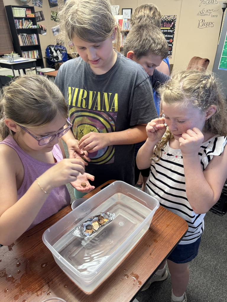 girls filling their boat with pennies.