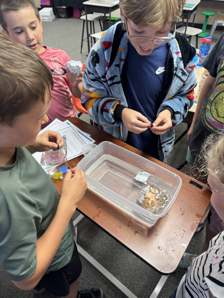 boys filling their foil boats with pennies.