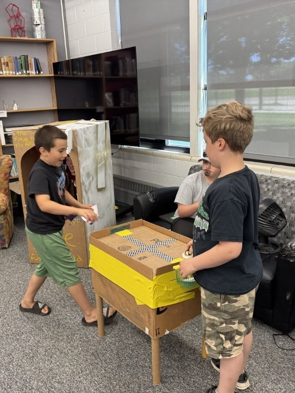 boys playing airhockey