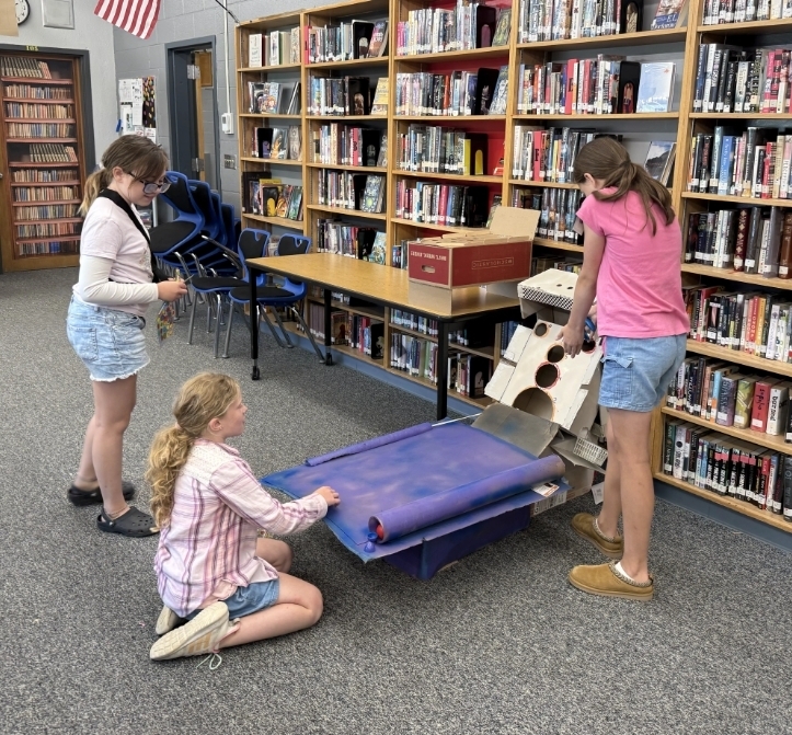 girls playing air hockey