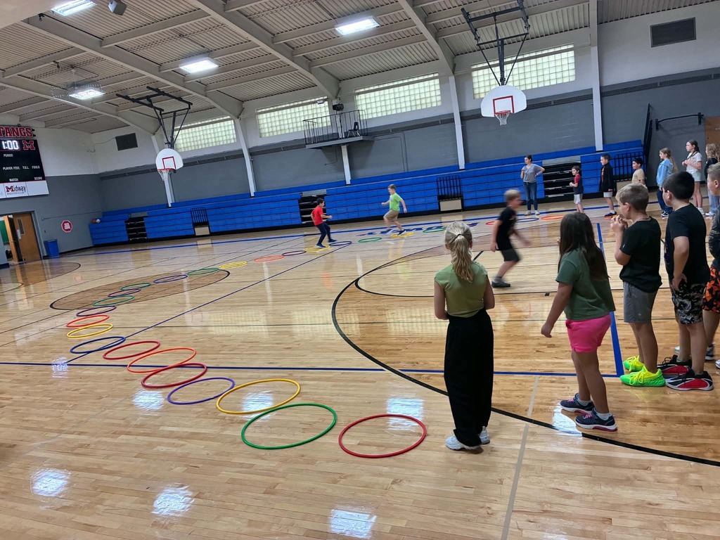 the kids hopping through the hila hoops