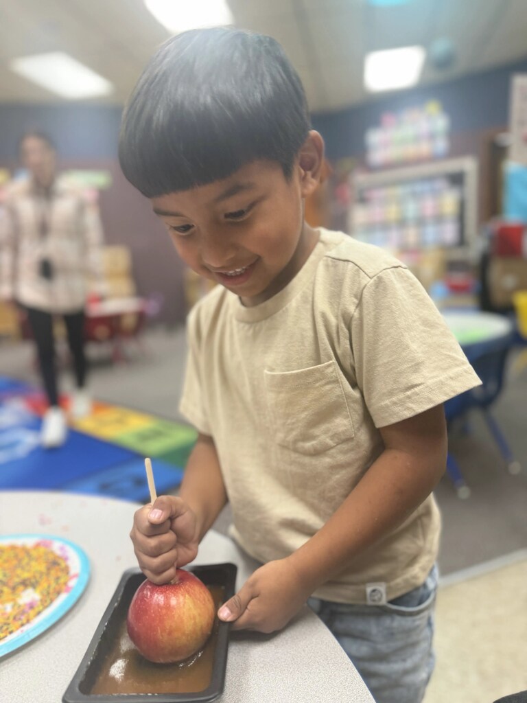a boy making a caramel apple