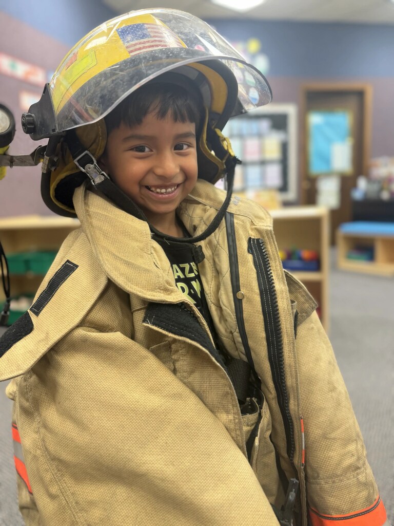 a boy trying on a jacket