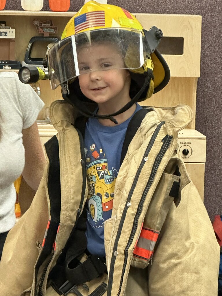 a boy in a fire jacket