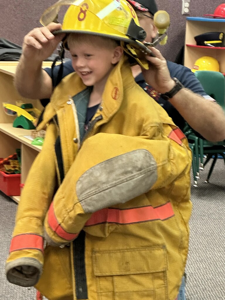 a boy in a in fireman's jacket