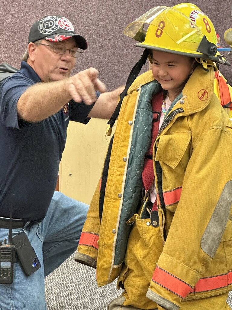 a girl in a fireman's jacket