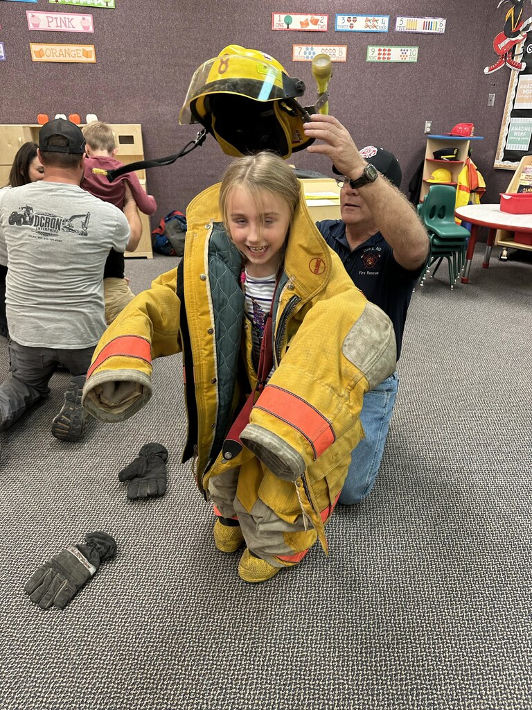a girl wearing the fire fighter gear