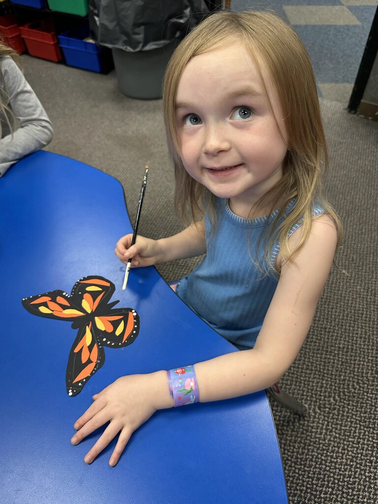 a girl painting her butterfly 