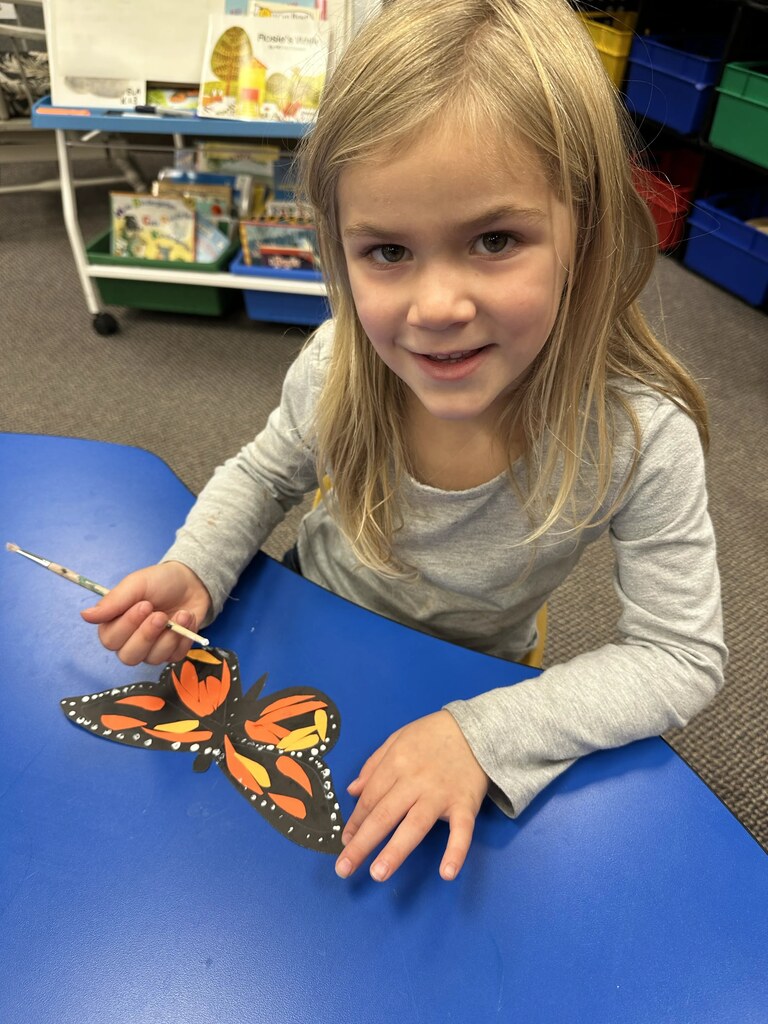 a girl painting her butterfly 