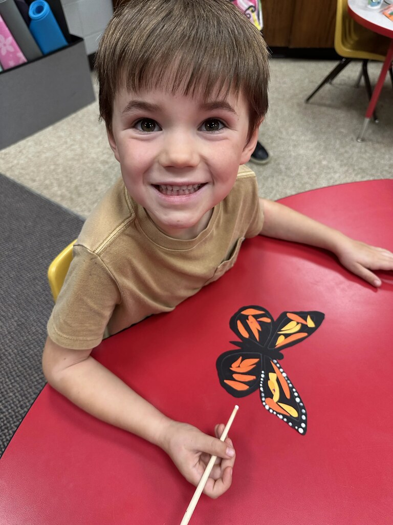 a boy painting his butterfly 