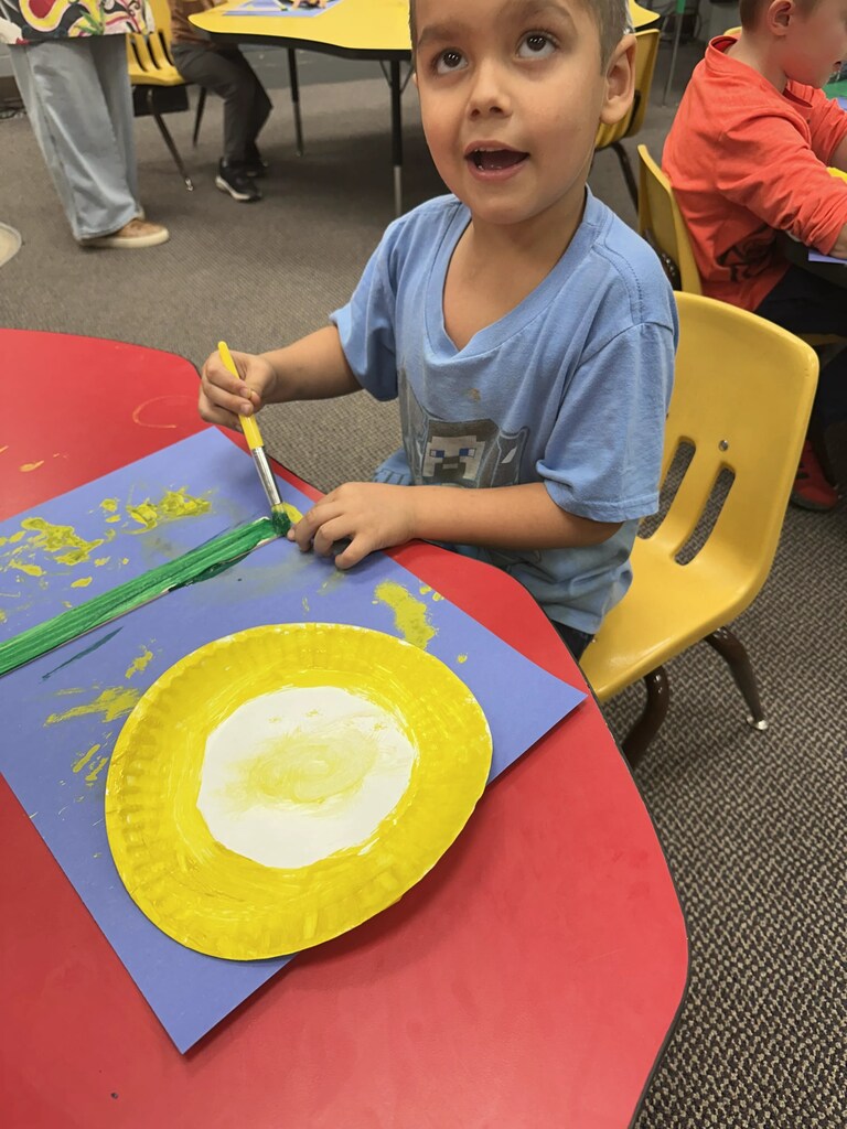 a kid painting a stick