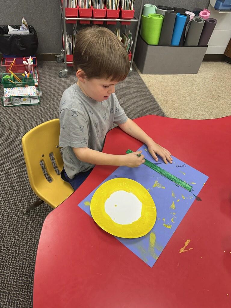a boy painting a stuck