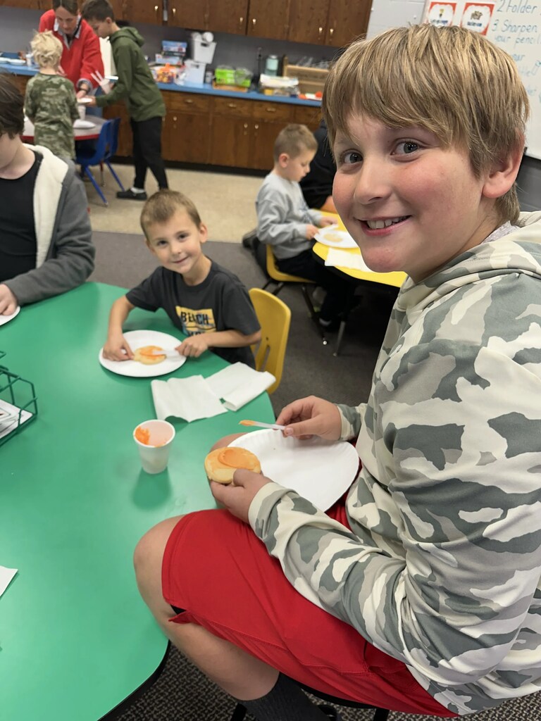 a boy and his buddy frosting cookies