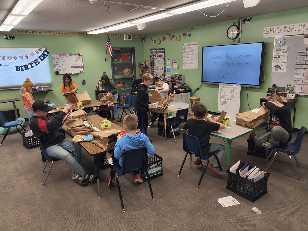 3rd graders opening their books!