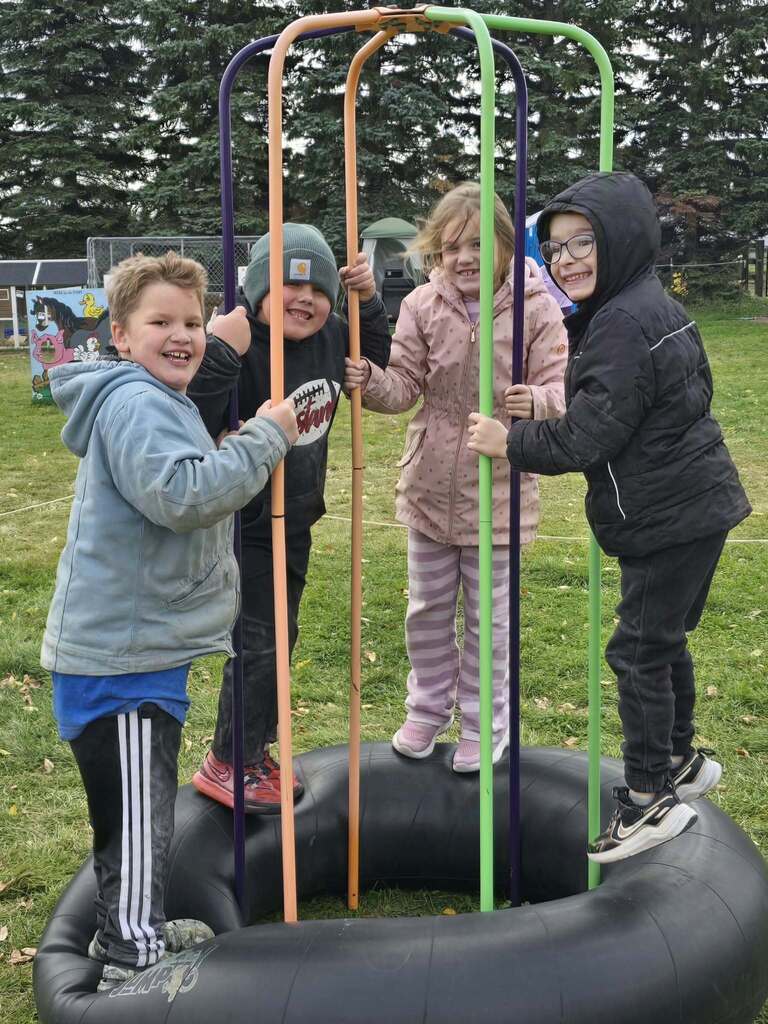 kids bouncing on the tire