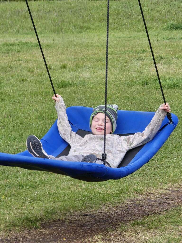 a kids relaxing on the swing