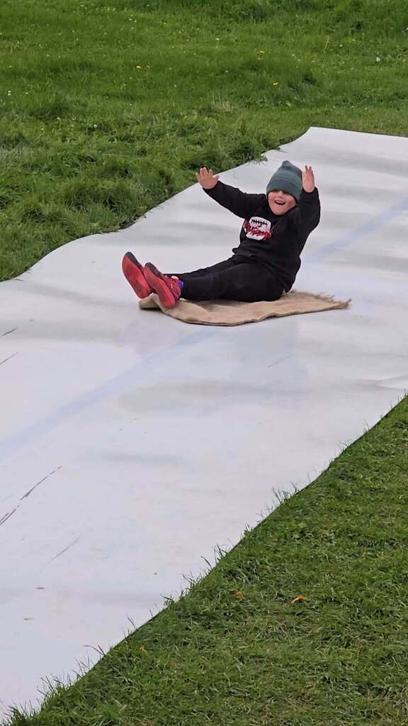 a boy going down a slide