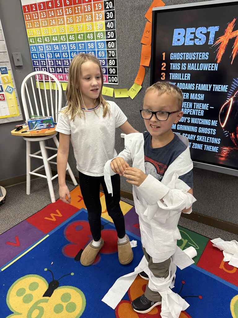a kid wrapped in tp