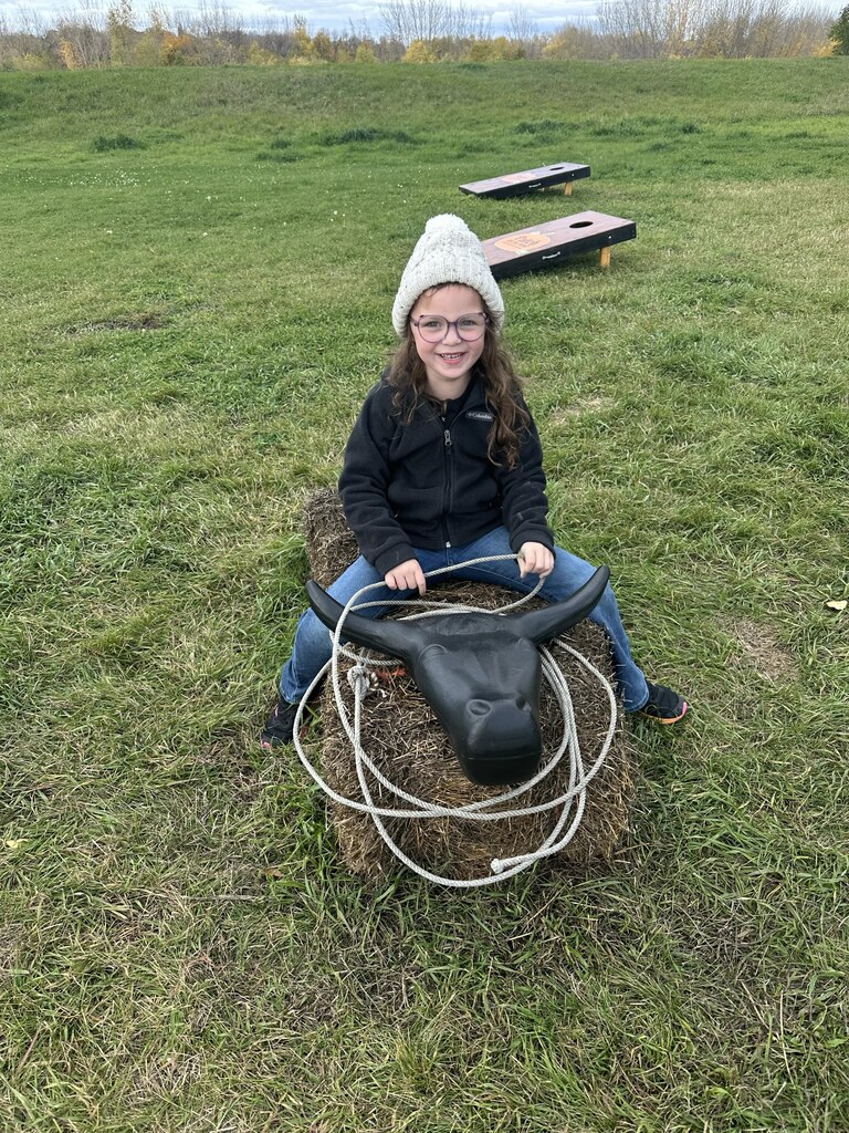 a girl roping a bull