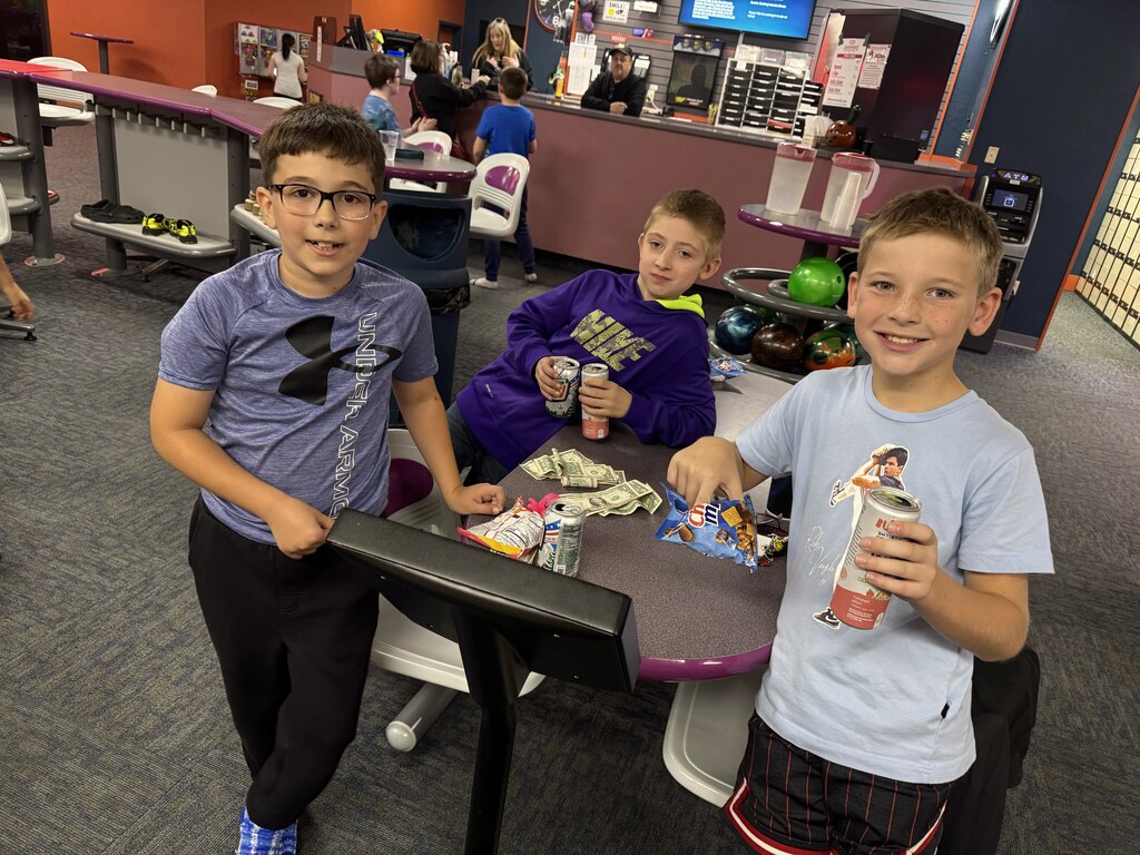 3 boys enjoying bowling