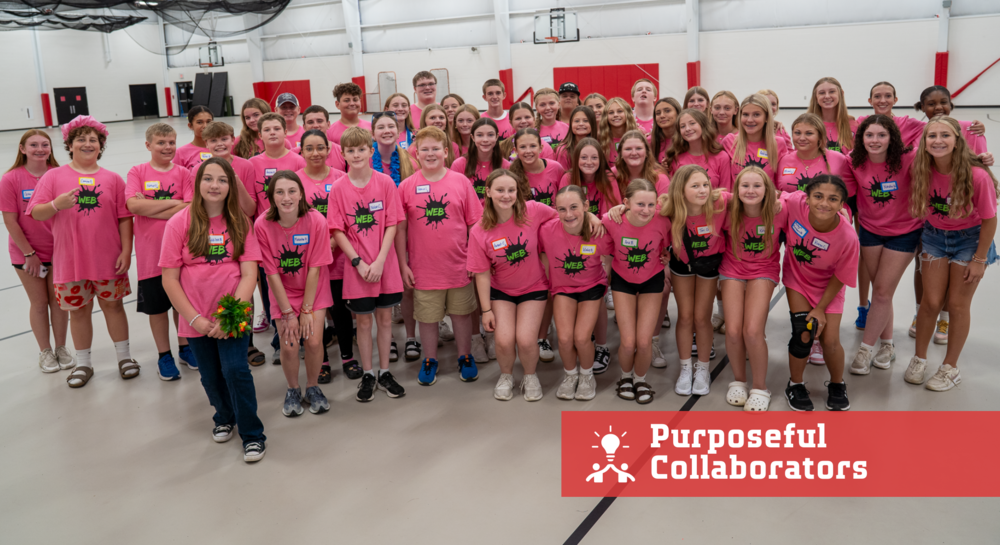 Group of students in pink shirts says web